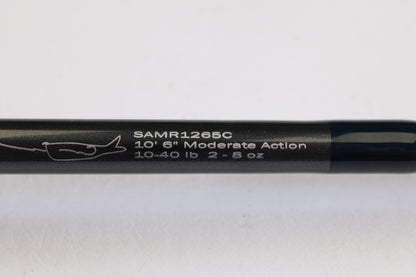 A close-up of the G. Loomis Salmon & Steelhead Mooching SAMR1265C 10'6" Heavy Casting Rod (used, mint) displays white model text, specs, and a fish hook graphic—ideal for our rod and reel trade-in program.