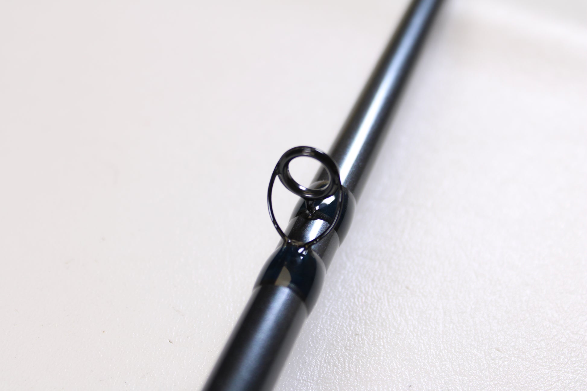 Close-up of a G. Loomis Salmon & Steelhead Mooching SAMR1265C 10'6" Heavy Used Casting Rod guide—ideal for anglers seeking a top-quality, mint condition upgrade for salmon and steelhead fishing.