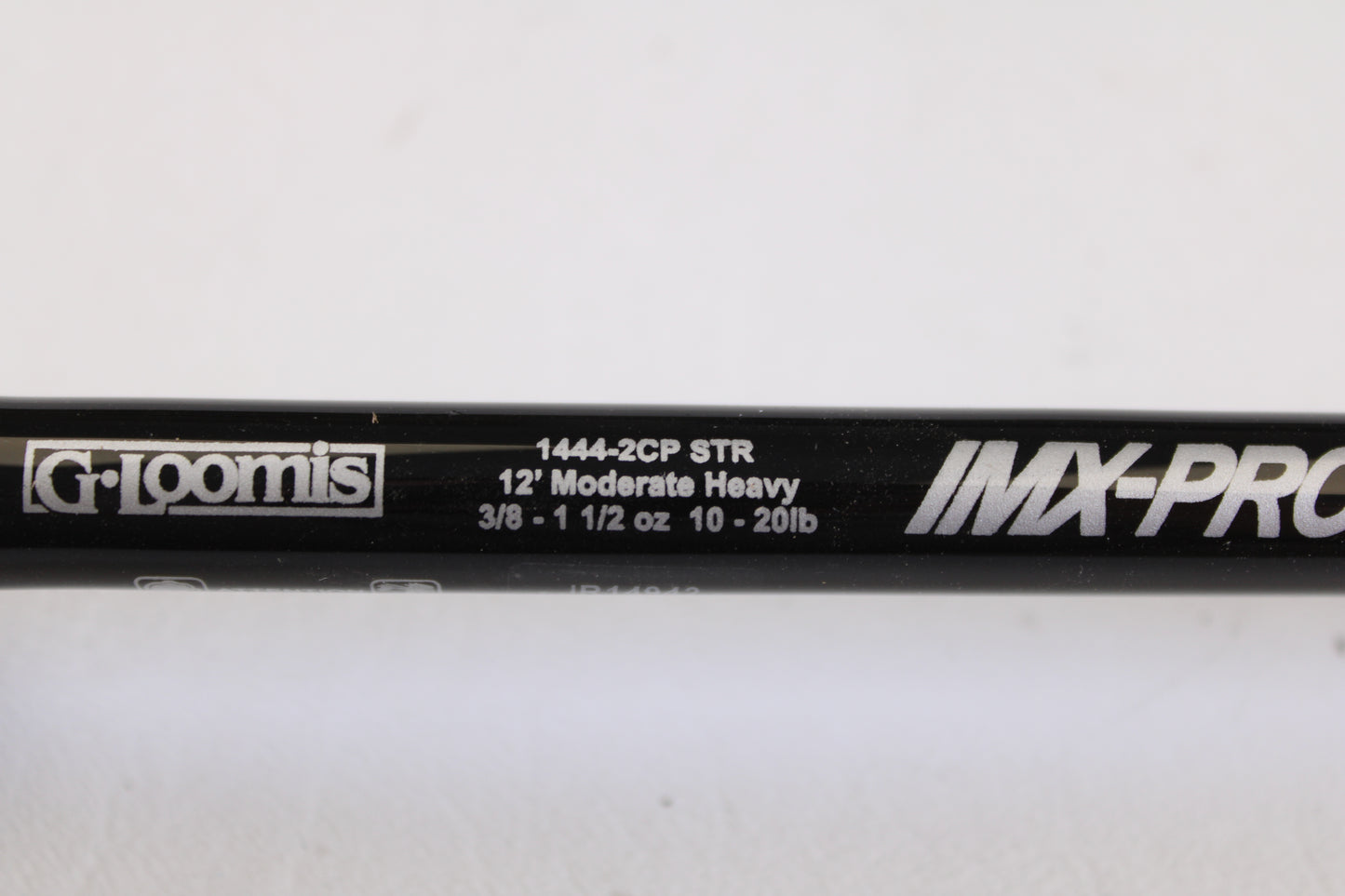 Close-up of a G. Loomis IMX-PRO Steelhead Centerpin 12'0" Heavy 2 Piece Spinning Rod (Used, Mint), with specs in white text. Upgrade now—trade your used gear for store credit with our Rod and Reel Trade-In Program!.
