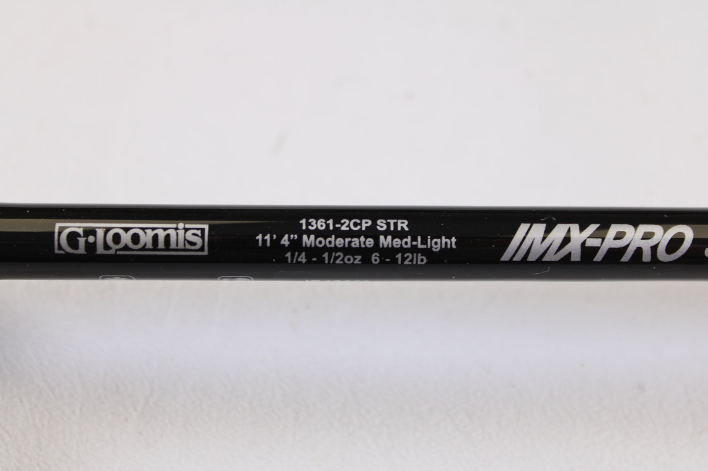 Close-up of a G. Loomis IMX-PRO Steelhead Centerpin 11'4" Medium Light 2 Piece Used Spinning Rod (Mint Condition) on a white background — ideal for our Rod and Reel Trade-In Program or to earn store credit on used gear.