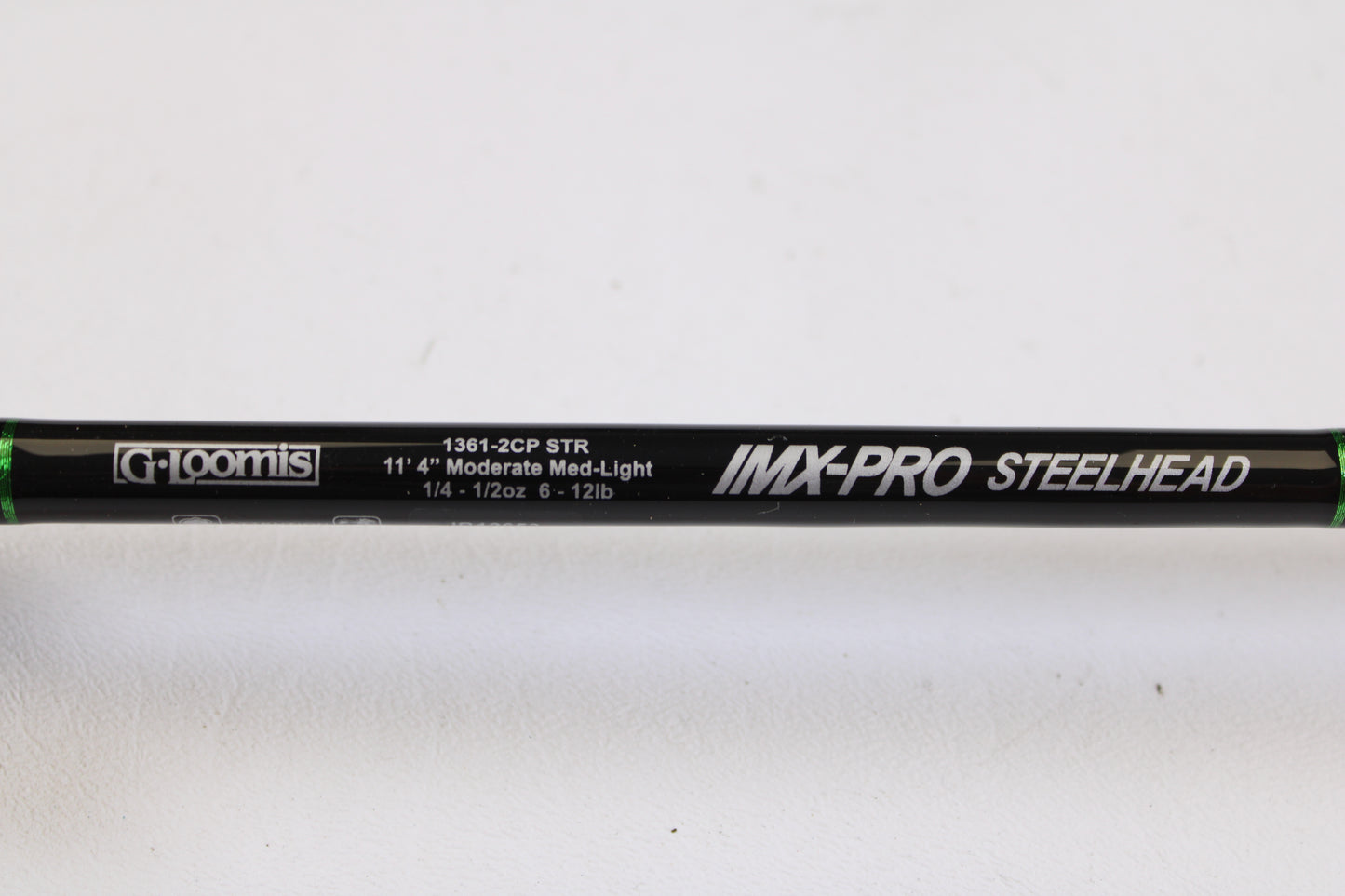 Close-up of a mint condition, used G. Loomis IMX-PRO Steelhead Centerpin 11'4" Medium Light 2-piece spinning rod—perfect for the Rod and Reel Trade-In Program to upgrade your gear and earn store credit.