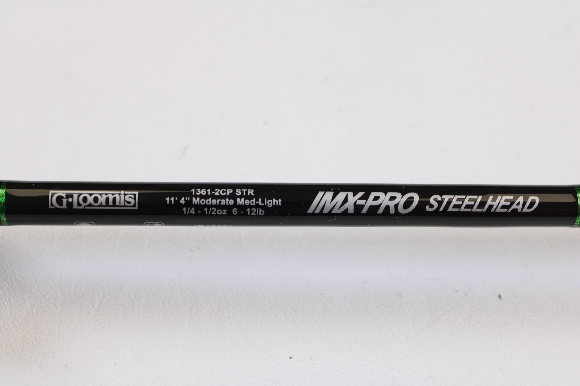 Close-up of a mint condition, used G. Loomis IMX-PRO Steelhead Centerpin 11'4" Medium Light 2-piece spinning rod—perfect for the Rod and Reel Trade-In Program to upgrade your gear and earn store credit.