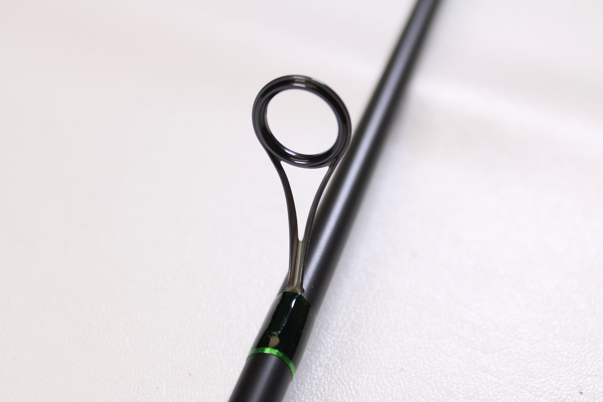 Close-up of a G. Loomis IMX-PRO Steelhead Centerpin 11'4" Medium Light 2 Piece Spinning Rod (Used, Mint Condition), showcasing a metal line guide—ideal for our Rod and Reel Trade-In Program if you’re upgrading your gear.