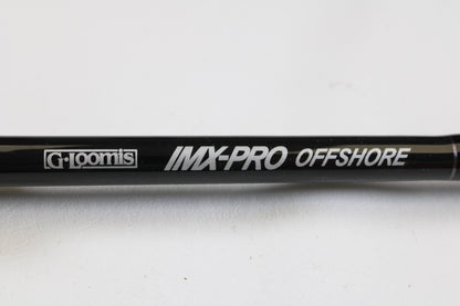 A close-up of the G. Loomis IMX-PRO Offshore 90-40 7'6" Medium Heavy Used Casting Rod in mint condition, with white "G. Loomis IMX-PRO OFFSHORE" text—ideal for those trading in rods or earning store credit with used gear.