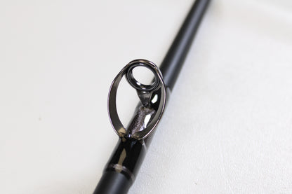 Close-up of the G. Loomis IMX-PRO Offshore 90-40 7'6" Medium Heavy Used Casting Rod in mint condition, highlighting its metal guide ring—ideal for anglers seeking top-quality pre-owned G. Loomis gear.