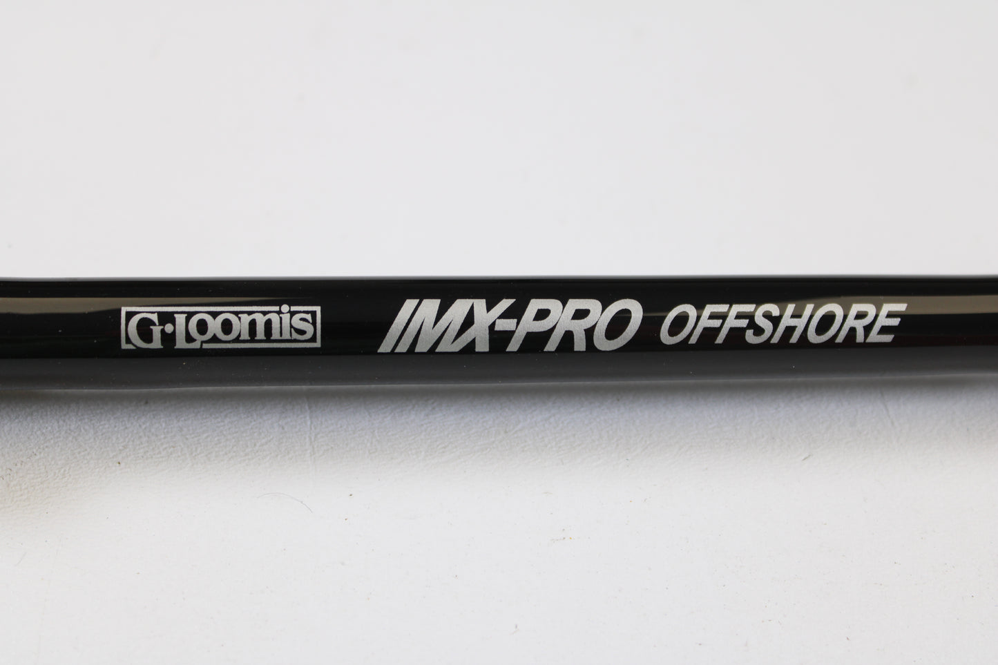 Close-up of a G. Loomis IMX-PRO Offshore 96-40 8'0" Medium Heavy Used Casting Rod—mint condition, eligible for our rod and reel trade-in program. Turn your used gear into store credit today!.