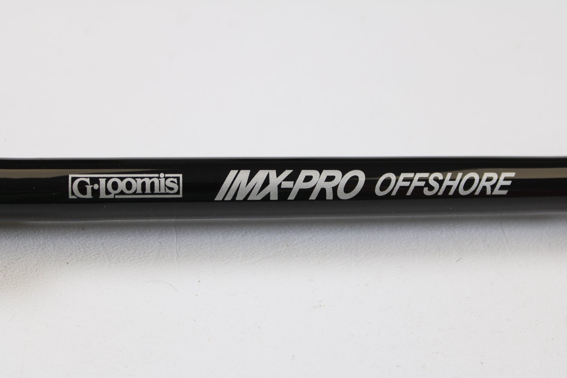 Close-up of a G. Loomis IMX-PRO Offshore 96-40 8'0" Medium Heavy Used Casting Rod—mint condition, eligible for our rod and reel trade-in program. Turn your used gear into store credit today!.