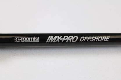 Close-up of a G. Loomis IMX-PRO Offshore 96-40 8'0" Medium Heavy Used Casting Rod—mint condition, eligible for our rod and reel trade-in program. Turn your used gear into store credit today!.
