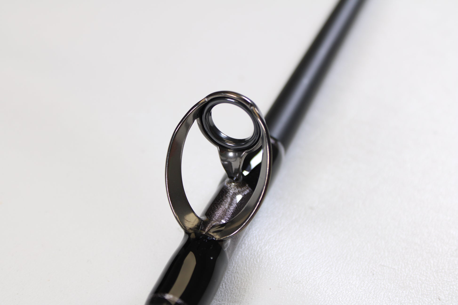 Close-up of the guide on a G. Loomis IMX-PRO Offshore 96-40 8'0" Medium Heavy Used Casting Rod in mint condition—ideal for anyone using our rod and reel trade-in program for store credit on used gear.