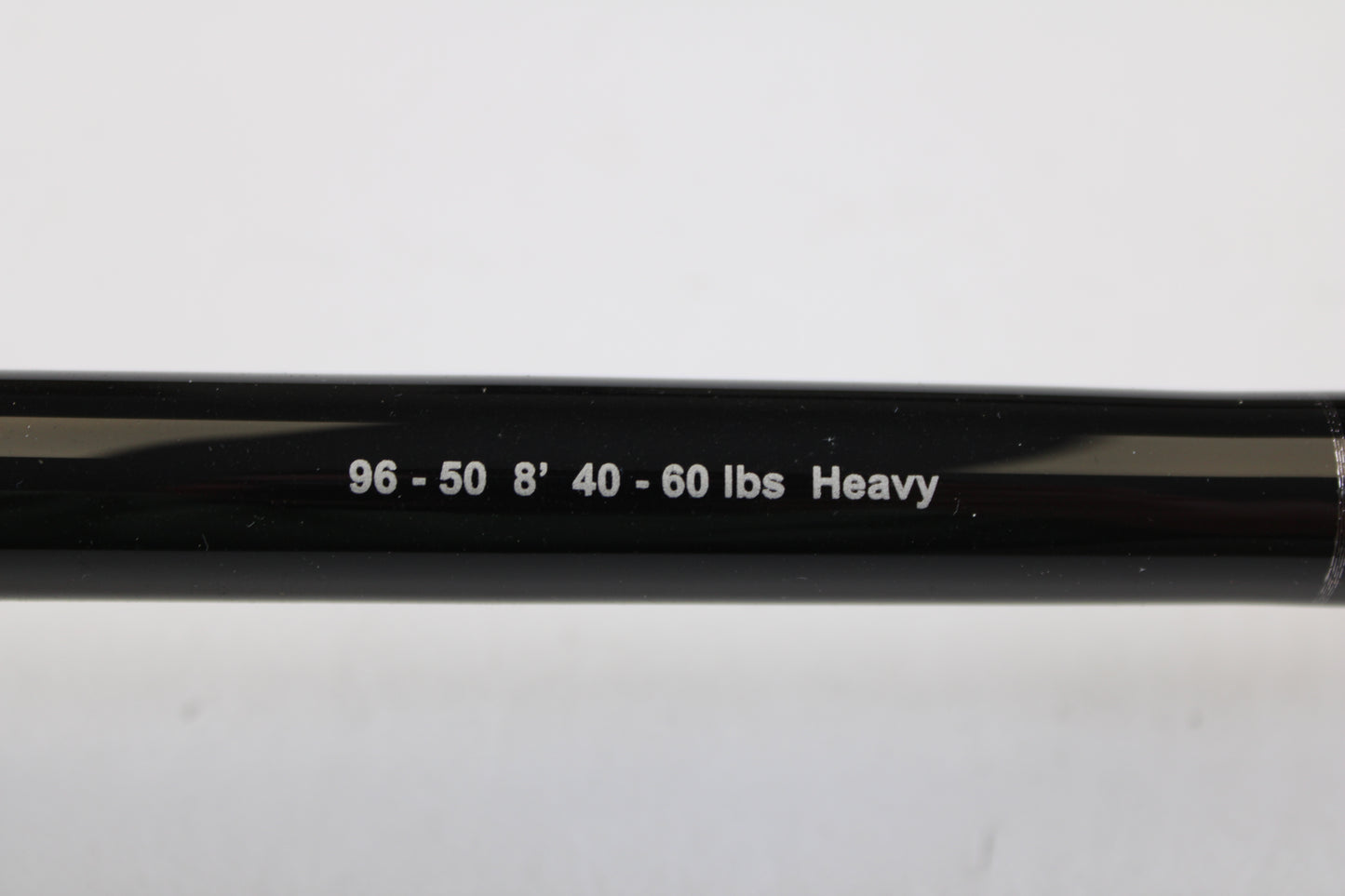 Close-up of a G. Loomis IMX-PRO Offshore 96-50 8'0" Heavy Used Casting Rod in mint condition, featuring white printed specs—ideal for your next trade-in or to explore in our quality used gear collection.
