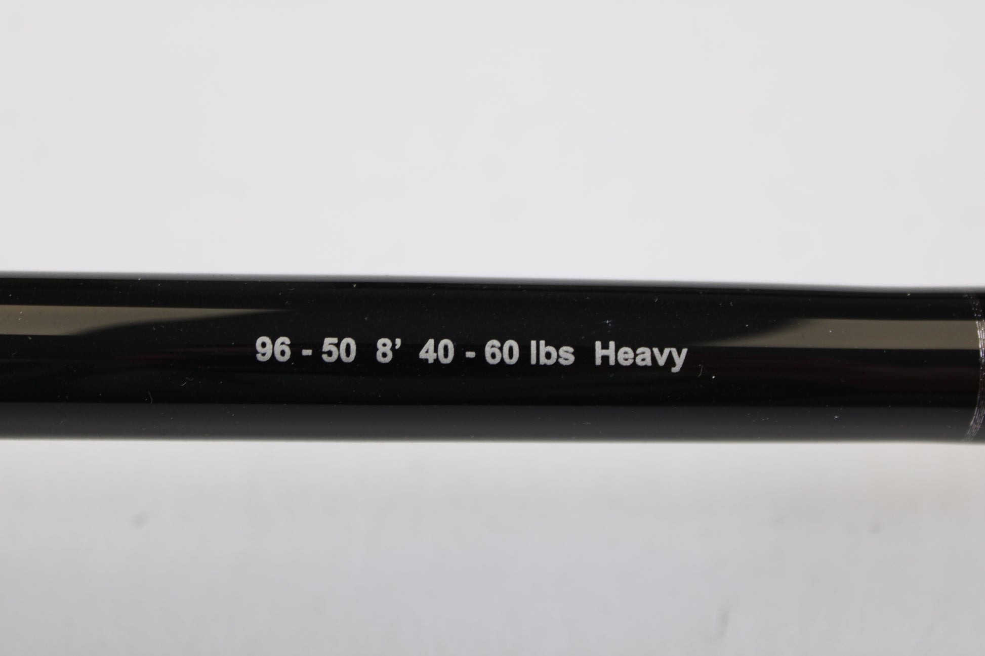 Close-up of a G. Loomis IMX-PRO Offshore 96-50 8'0" Heavy Used Casting Rod in mint condition, featuring white printed specs—ideal for your next trade-in or to explore in our quality used gear collection.