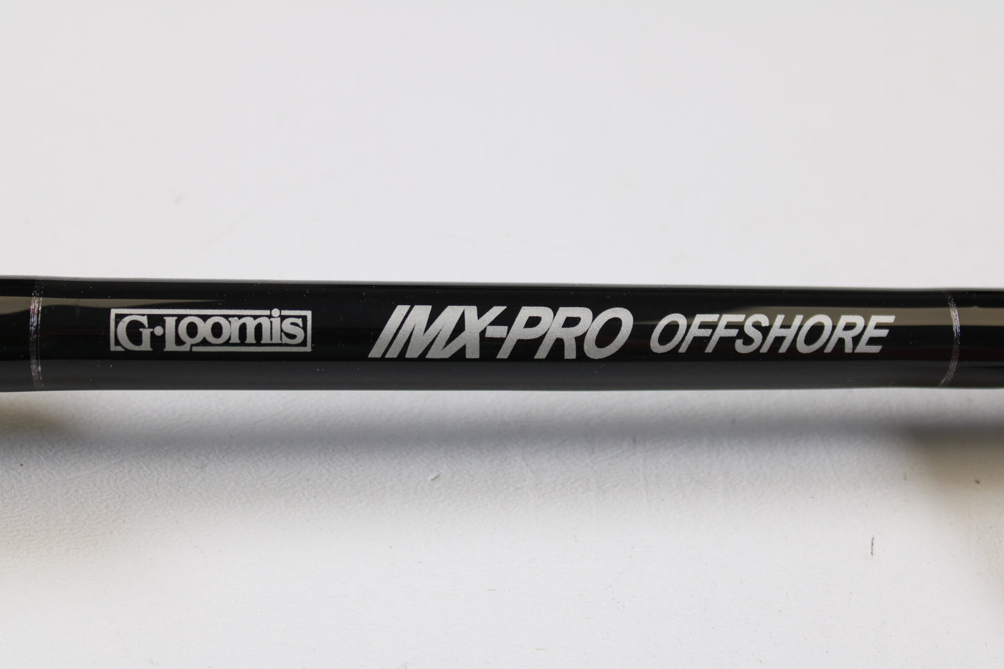 Close-up of a G. Loomis IMX-PRO Offshore 96-50 8'0" Heavy used casting rod in mint condition—perfect for anglers looking to upgrade via our rod and reel trade-in program or earn store credit on used gear.