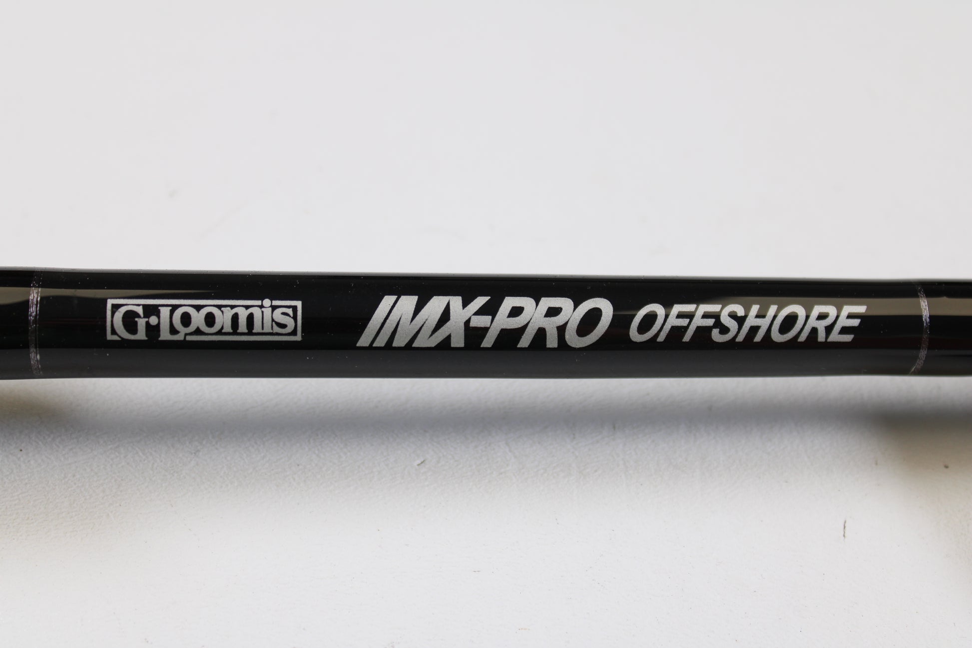 Close-up of a G. Loomis IMX-PRO Offshore 96-50 8'0" Heavy used casting rod in mint condition—perfect for anglers looking to upgrade via our rod and reel trade-in program or earn store credit on used gear.