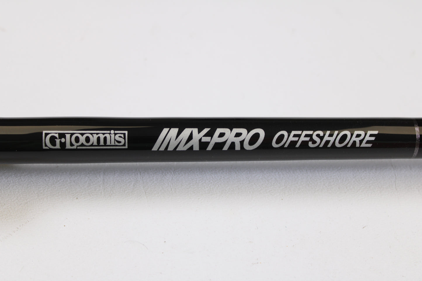Close-up of a G. Loomis IMX-PRO Offshore 96-20 8'0" Medium Light Used Casting Rod in mint condition, ideal for customers upgrading with our Rod and Reel Trade-In Program for store credit.