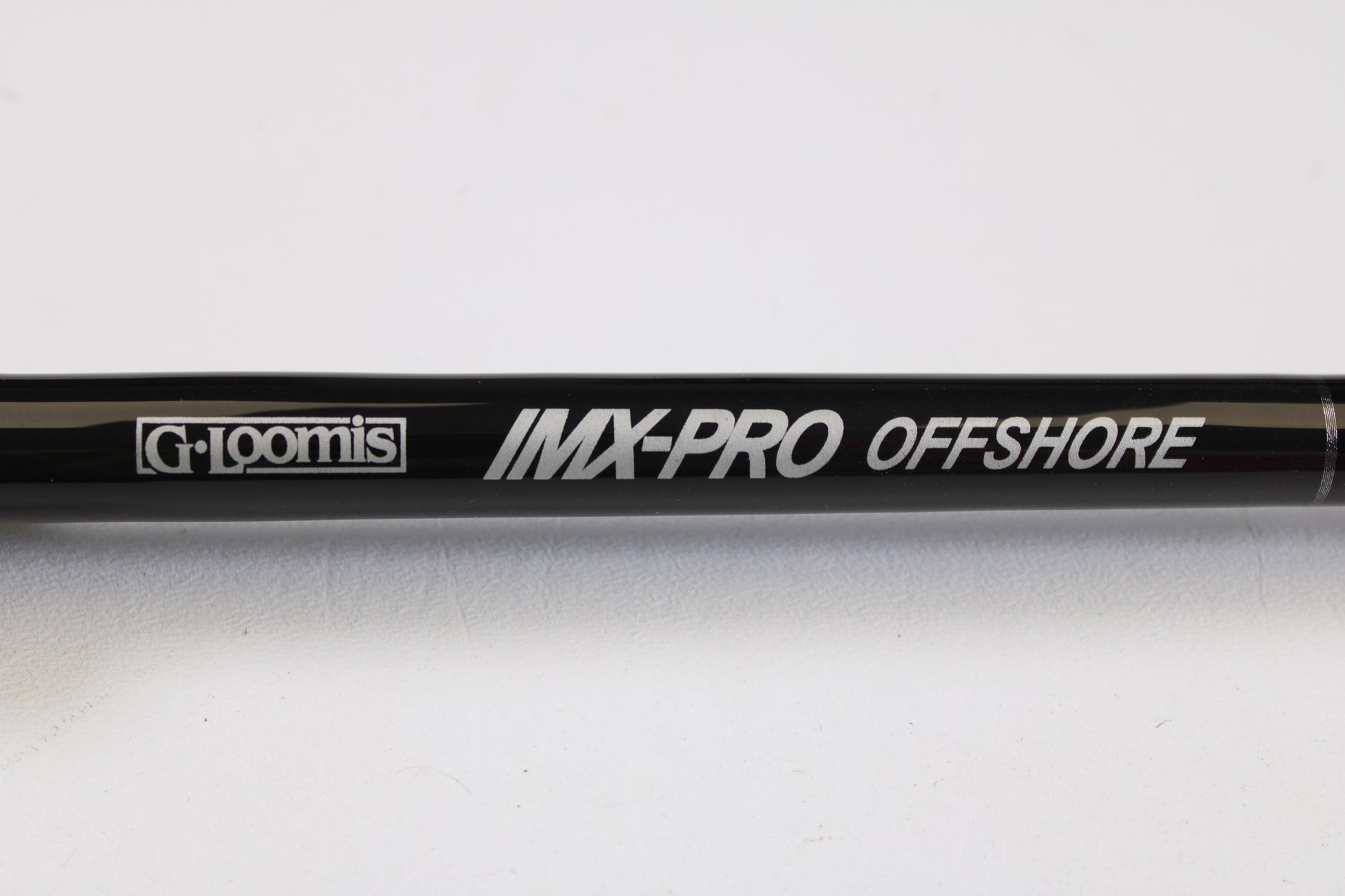Close-up of a G. Loomis IMX-PRO Offshore 96-20 8'0" Medium Light Used Casting Rod in mint condition, ideal for customers upgrading with our Rod and Reel Trade-In Program for store credit.