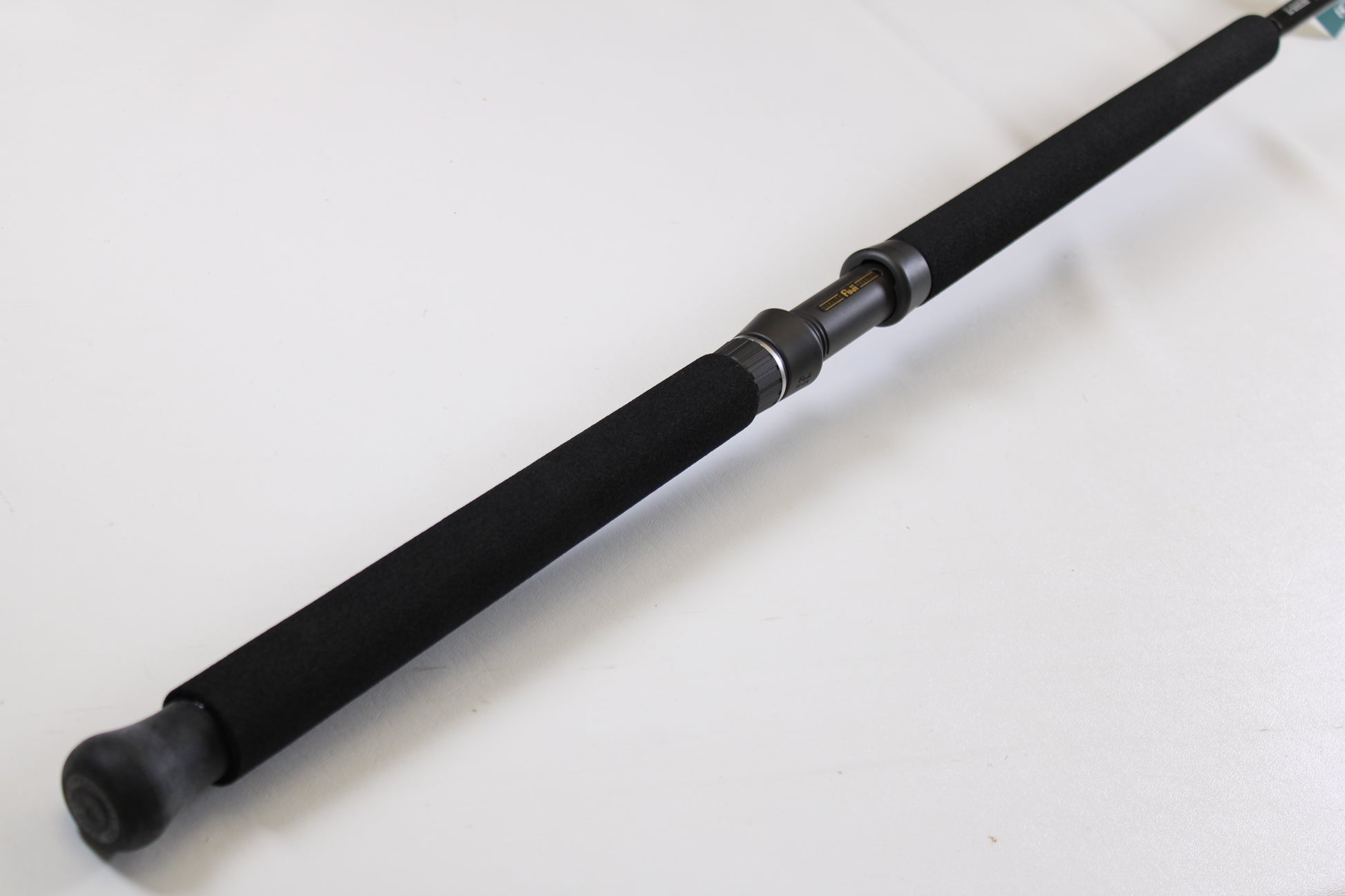 A close-up of the G. Loomis IMX-PRO Offshore 90-50 7'6" Heavy, a black used casting rod in mint condition, with foam grip and metal reel seat—ideal for anglers using our Rod and Reel Trade-In Program for store credit.