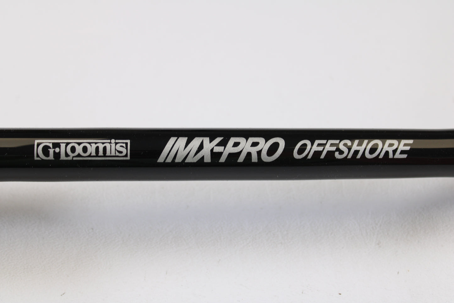 Close-up of a G. Loomis IMX-PRO Offshore 90-50 7'6" Heavy Used Casting Rod in mint condition—ideal for anglers interested in used gear or taking advantage of our Rod and Reel Trade-In Program for store credit.
