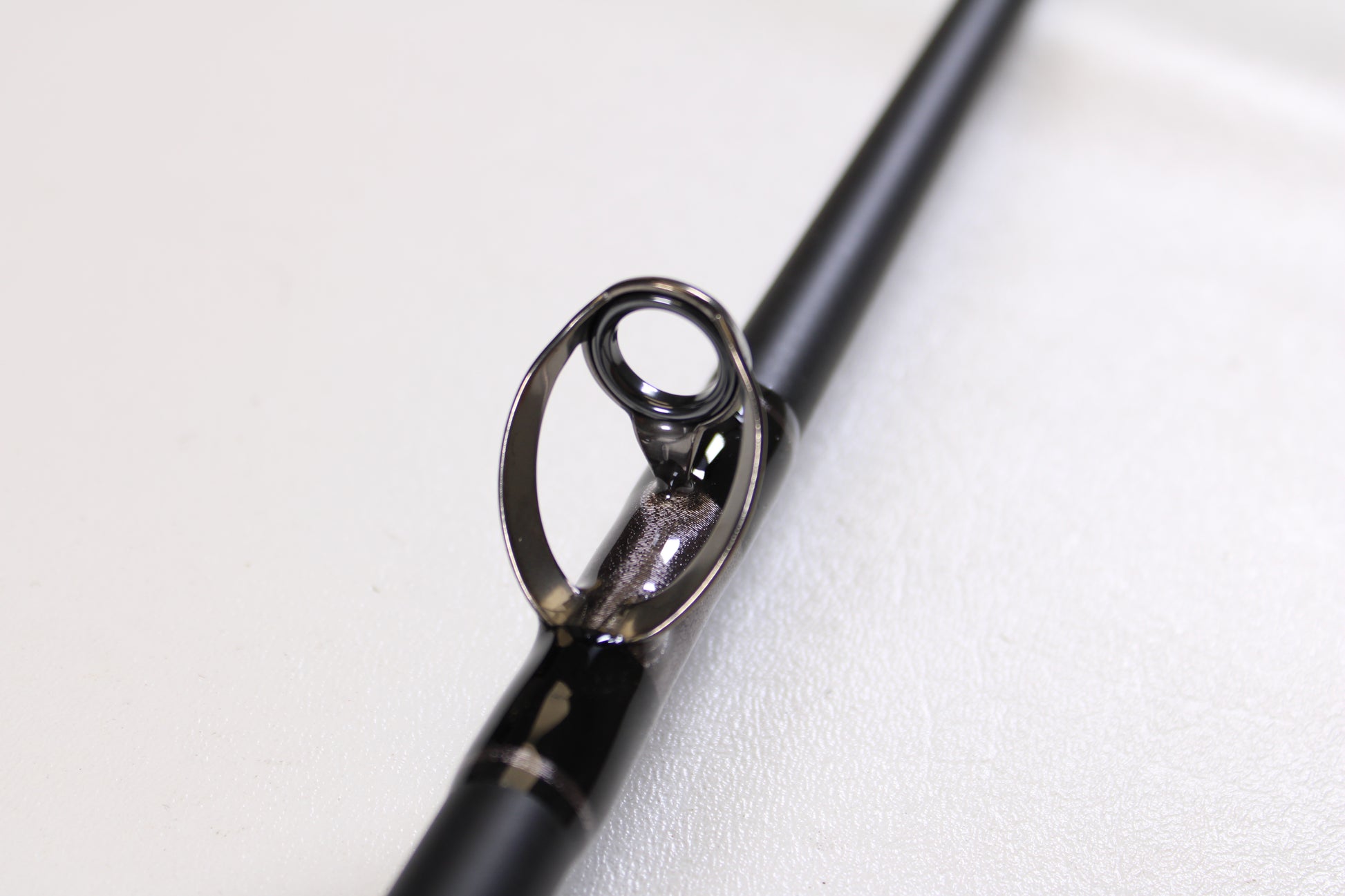 Close-up of a G. Loomis IMX-PRO Offshore 90-50 7'6" Heavy Used Casting Rod guide, displaying the ring and frame detail—ideal for anglers looking to trade up through our Rod and Reel Trade-In Program for store credit.