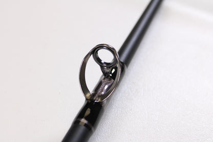 Close-up of a G. Loomis IMX-PRO Offshore 90-50 7'6" Heavy Used Casting Rod guide, displaying the ring and frame detail—ideal for anglers looking to trade up through our Rod and Reel Trade-In Program for store credit.