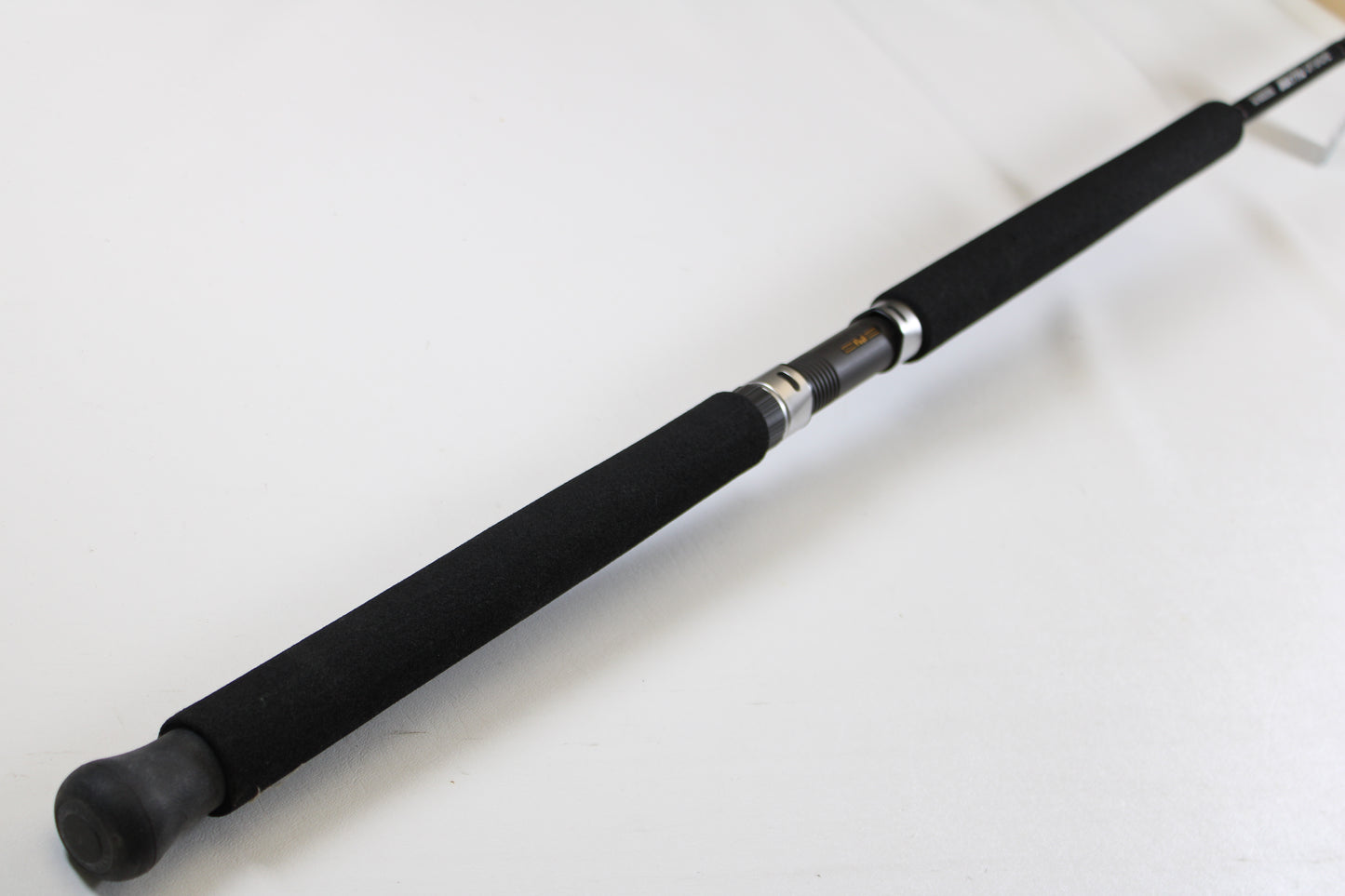 A close-up of the G. Loomis IMX-PRO Offshore 96-30 8'0" Medium Used Casting Rod (Mint Condition) handle against a white background—ideal for those looking to trade in used G. Loomis gear for store credit through our Trade-In Program.