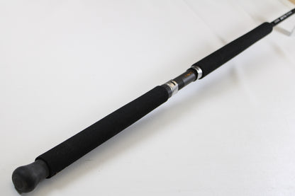 A close-up of the G. Loomis IMX-PRO Offshore 96-30 8'0" Medium Used Casting Rod (Mint Condition) handle against a white background—ideal for those looking to trade in used G. Loomis gear for store credit through our Trade-In Program.