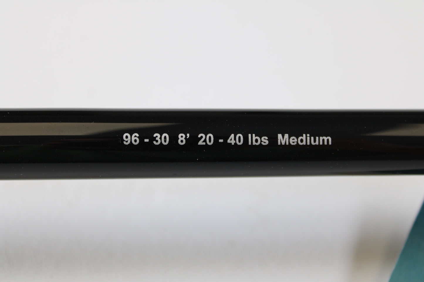 Close-up of a G. Loomis IMX-PRO Offshore 96-30 8'0" Medium Used Casting Rod (Mint Condition) shows its white printed specs—great for our Rod and Reel Trade-In Program if you’re ready to upgrade your used gear.