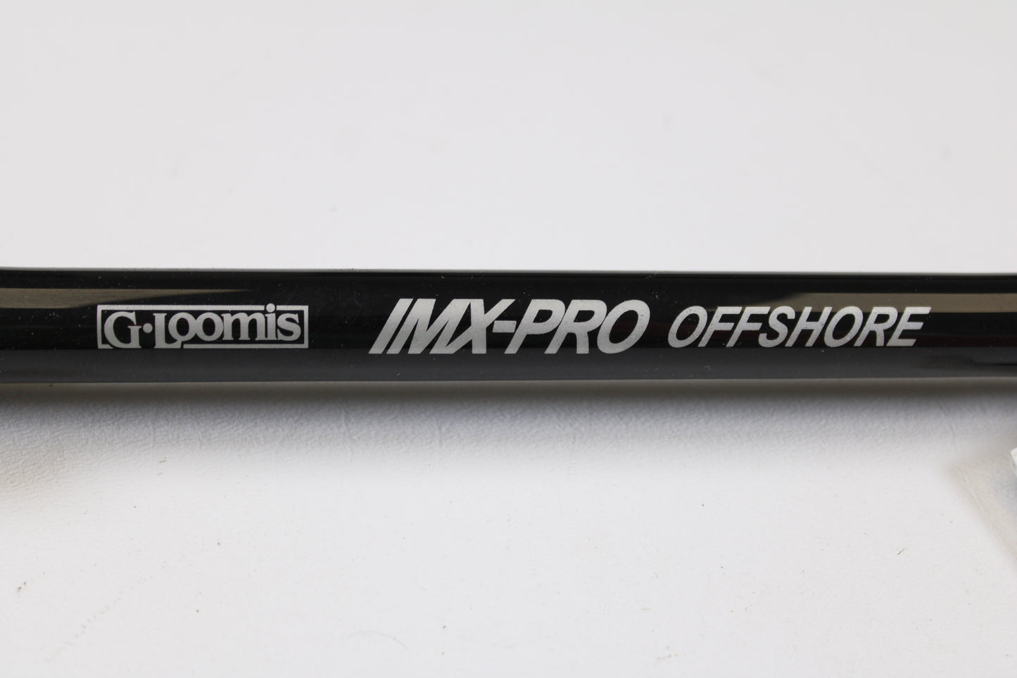 Close-up of a G. Loomis IMX-PRO Offshore 90-60 7'6" XH Used Casting Rod in mint condition, ideal for anglers seeking quality used gear or those interested in our rod and reel trade-in program.