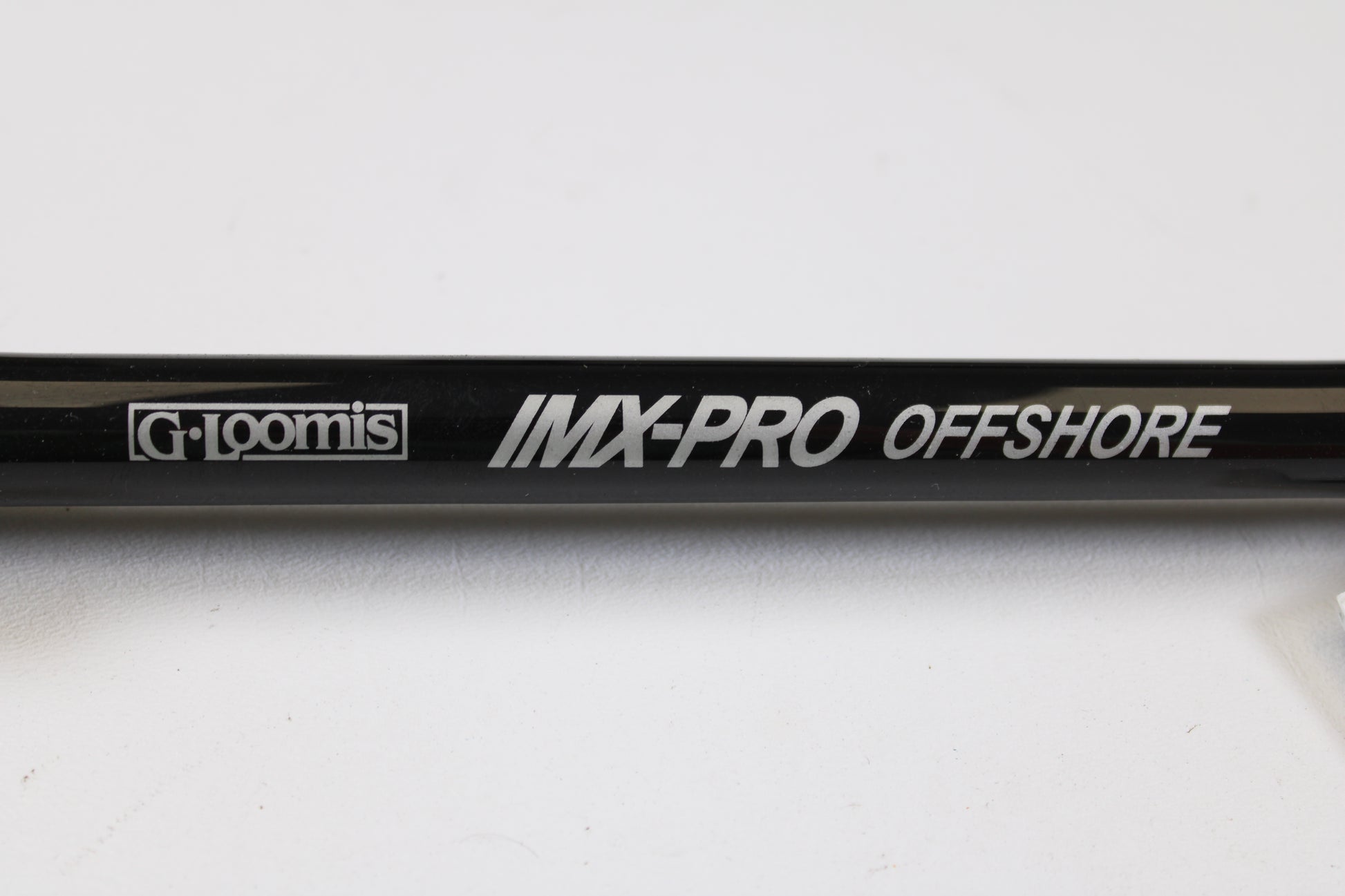 Close-up of a G. Loomis IMX-PRO Offshore 90-60 7'6" XH Used Casting Rod in mint condition, ideal for anglers seeking quality used gear or those interested in our rod and reel trade-in program.