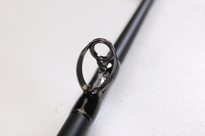 Close-up of the G. Loomis IMX-PRO Offshore 90-60 7'6" XH used casting rod in mint condition, highlighting the metal guide—perfect for anglers exploring quality pre-owned gear or considering our rod and reel trade-in options.