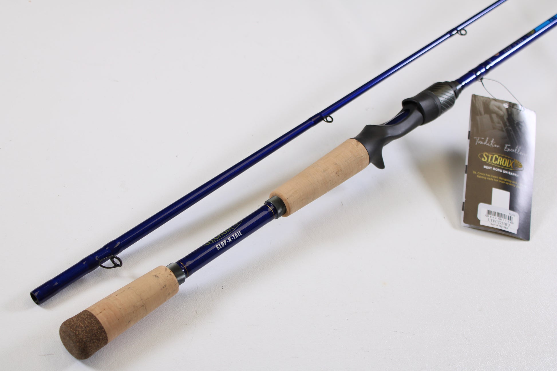 A St. Croix Legend Tournament Pike LTPC223HF2 Slop N Tail 7'4" Heavy 2-piece used casting rod (mint condition) with cork handle is shown. Eligible for our rod and reel trade-in—exchange used gear for store credit.