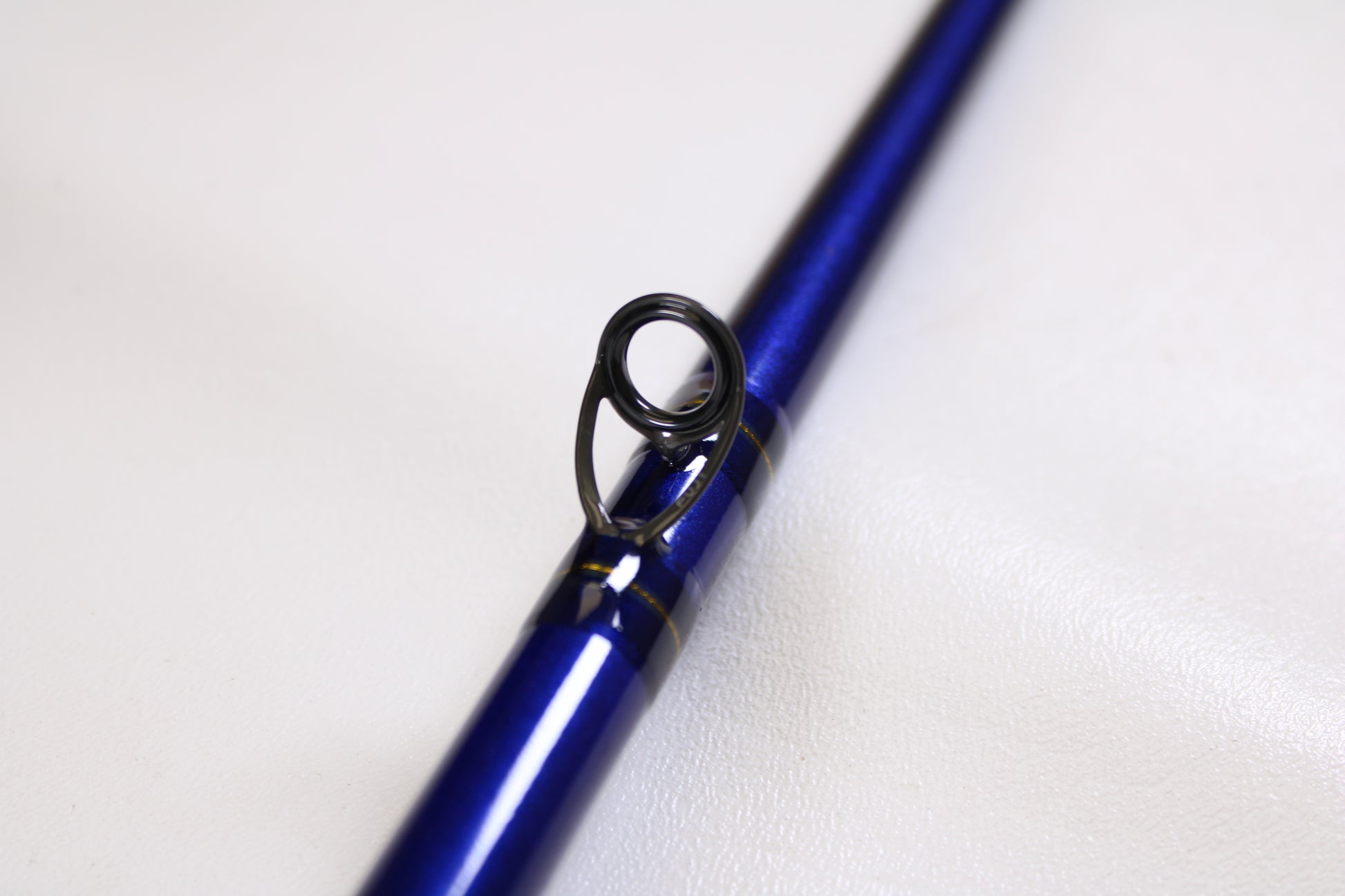 A close-up of the St. Croix Legend Tournament Pike LTPC259XHF2 8'6" Used Casting Rod—shown for our Rod and Reel Trade-In Program—highlights a line guide, ideal for anglers looking to upgrade used St. Croix gear for store credit.
