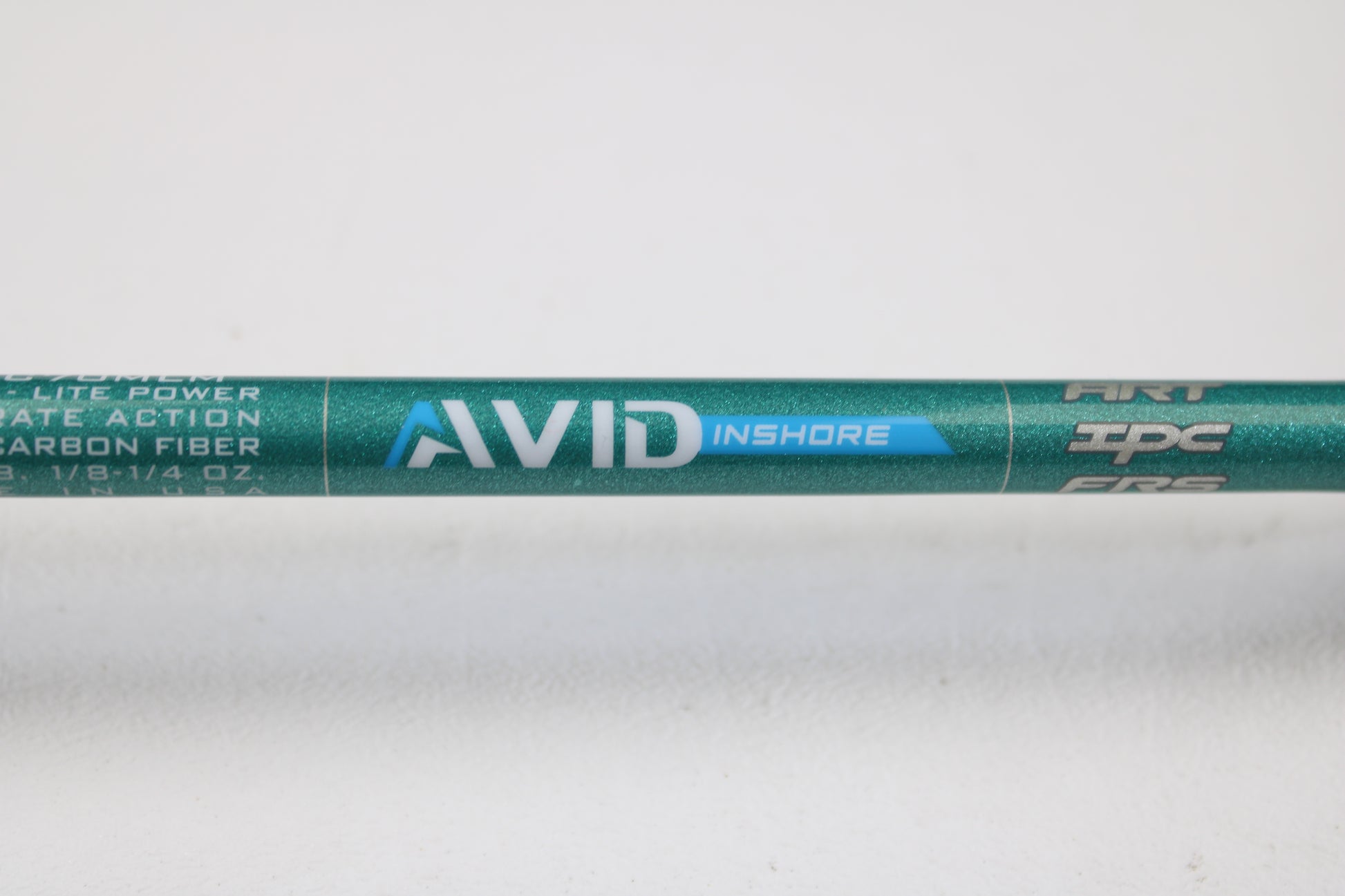 A close-up of the St. Croix Avid Inshore ASIC70MLM 7'0" Medium Light Used Casting Rod in mint condition. "AVID INSHORE" appears in white and blue on the green rod, shown against a plain white background—ideal for trade-in or used gear seekers.