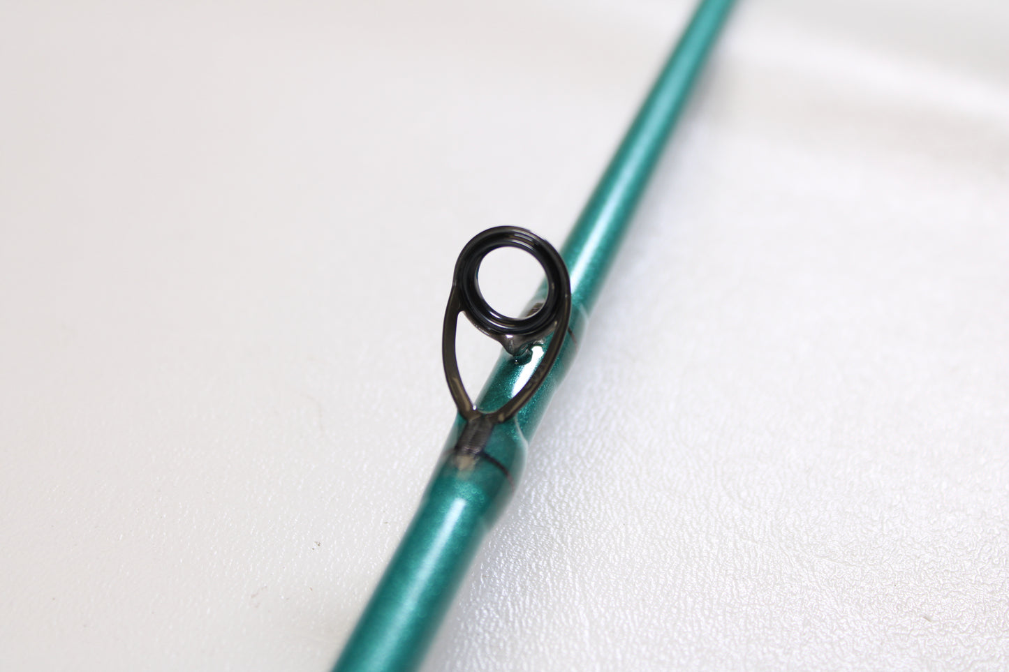 Close-up of a St. Croix Avid Inshore ASIC70MLM 7'0" Medium Light Used Casting Rod in mint condition, highlighting a black metal line guide—ideal for those interested in our Rod and Reel Trade-In Program for store credit.