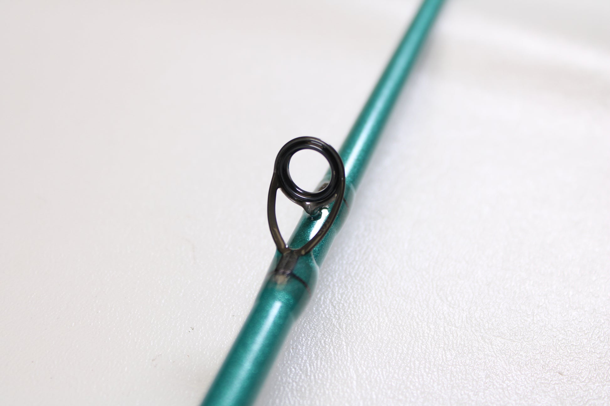 Close-up of a St. Croix Avid Inshore ASIC70MLM 7'0" Medium Light Used Casting Rod in mint condition, highlighting a black metal line guide—ideal for those interested in our Rod and Reel Trade-In Program for store credit.