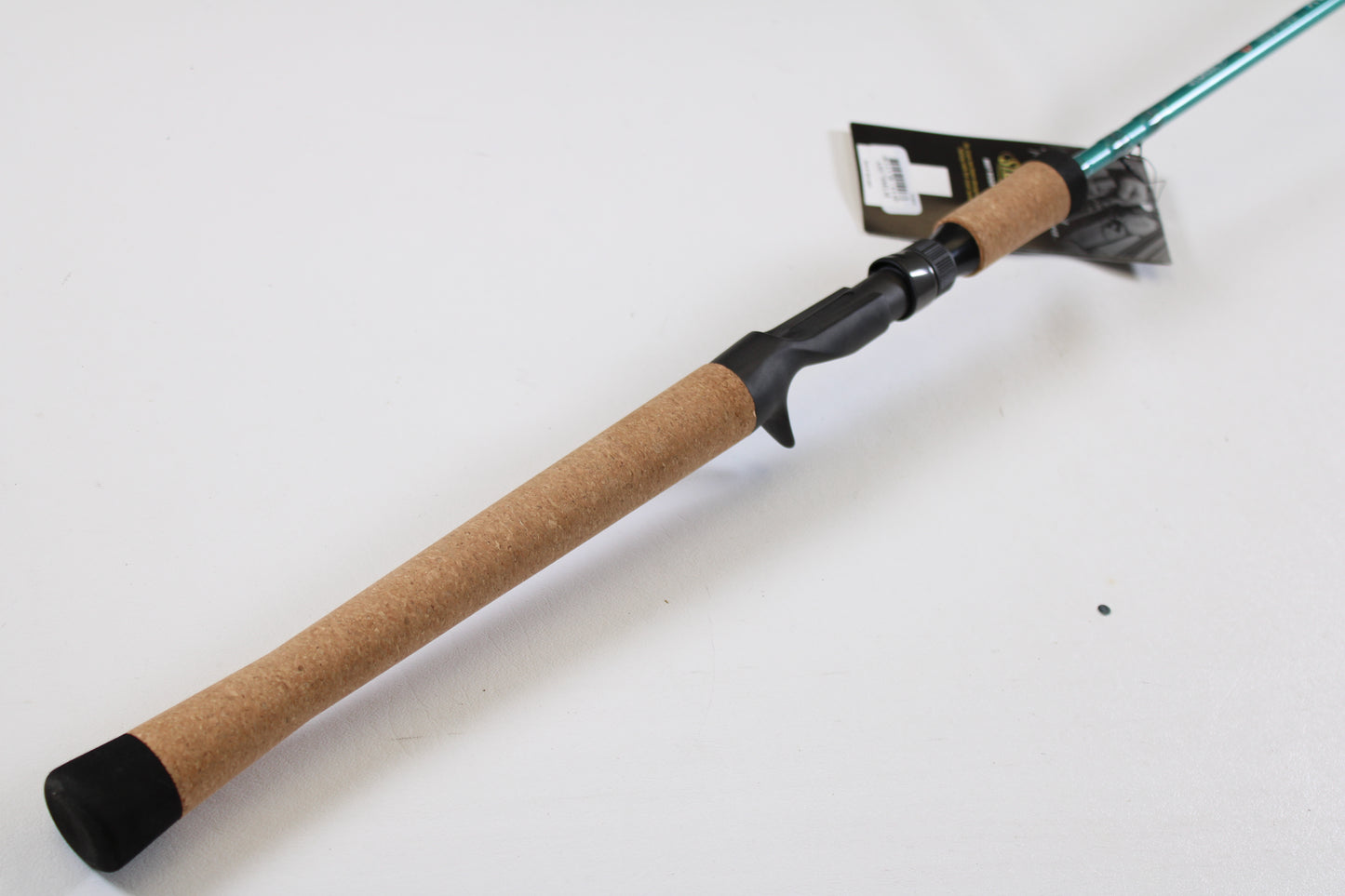 The St. Croix Avid Inshore ASIC76MLM 7'6" Medium Light Used Casting Rod, in mint condition, features a cork handle and black reel seat with a product tag—perfect for those interested in our rod and reel trade-in or used gear program.