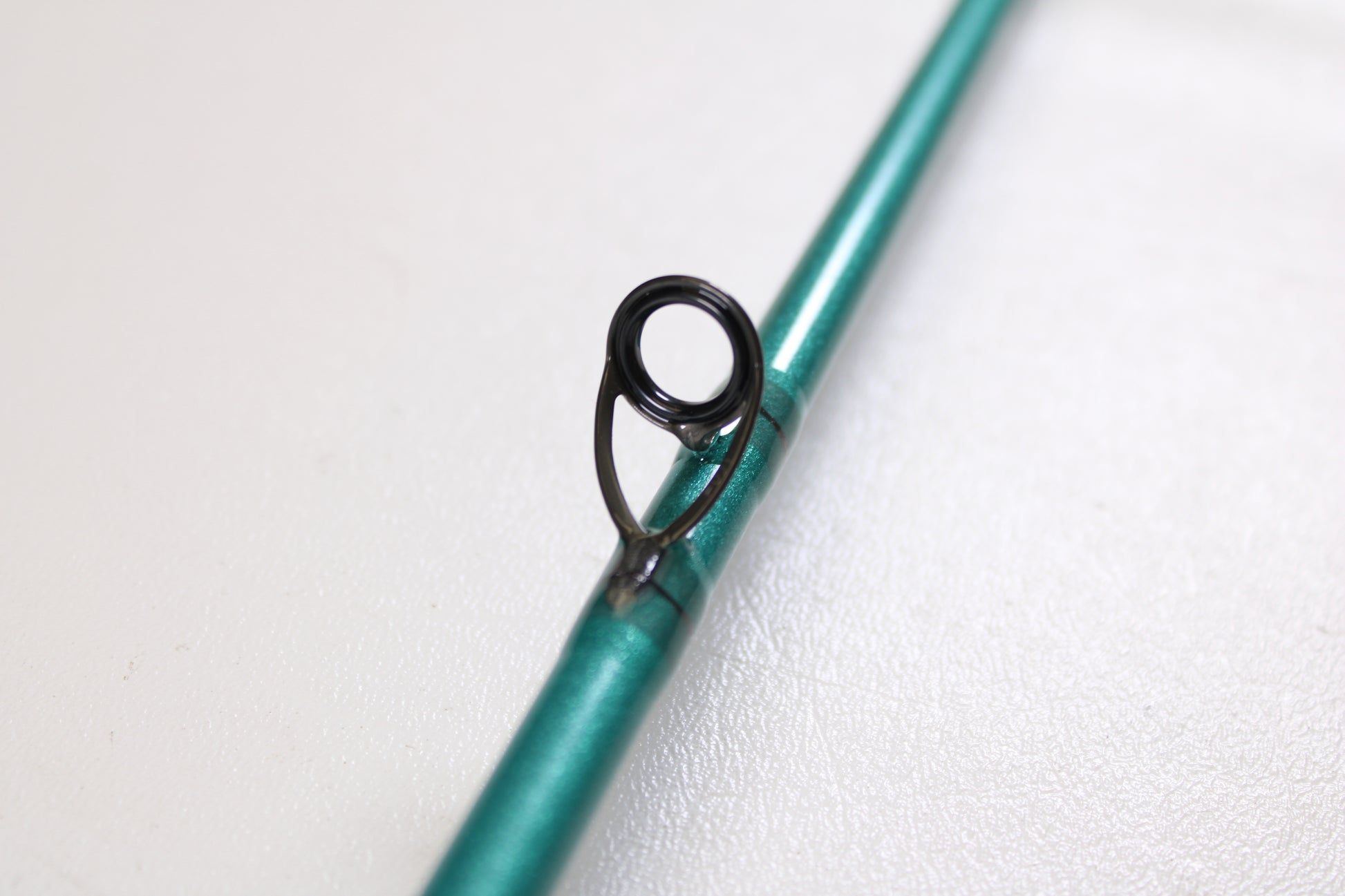 Close-up of a St. Croix Avid Inshore ASIC76MLM 7'6" Medium Light Used Casting Rod in mint condition, showcasing its black line guide—perfect for upgrading your gear or trading in your old rod for store credit.