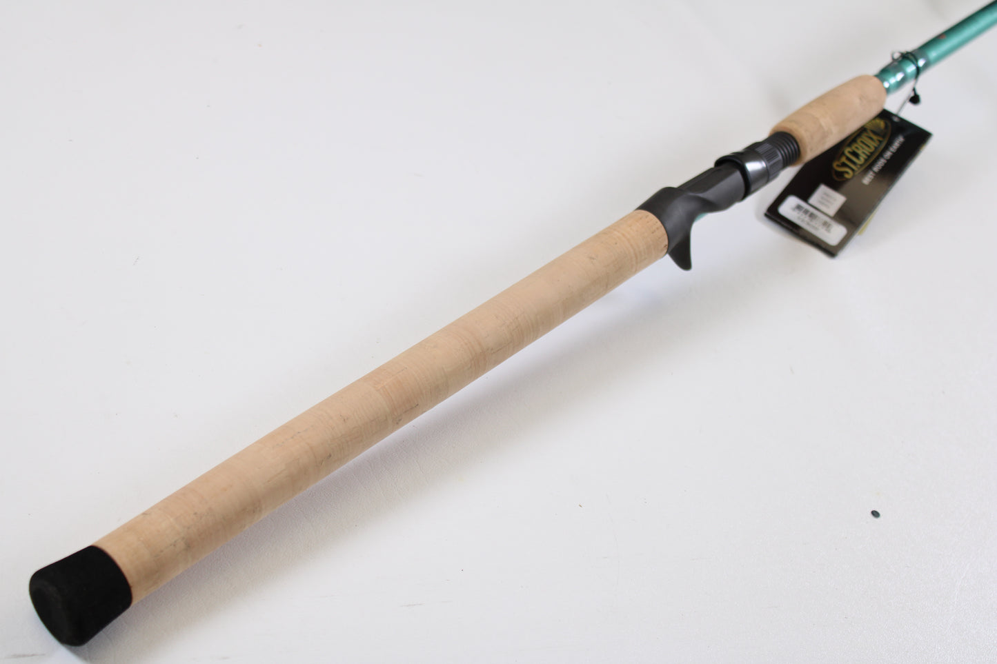 A close-up of the St. Croix Avid Inshore VIC80HF 8'0" Heavy casting rod handle, featuring a cork grip and black reel seat—ideal for those seeking top-quality used rods or participating in our trade-in program.