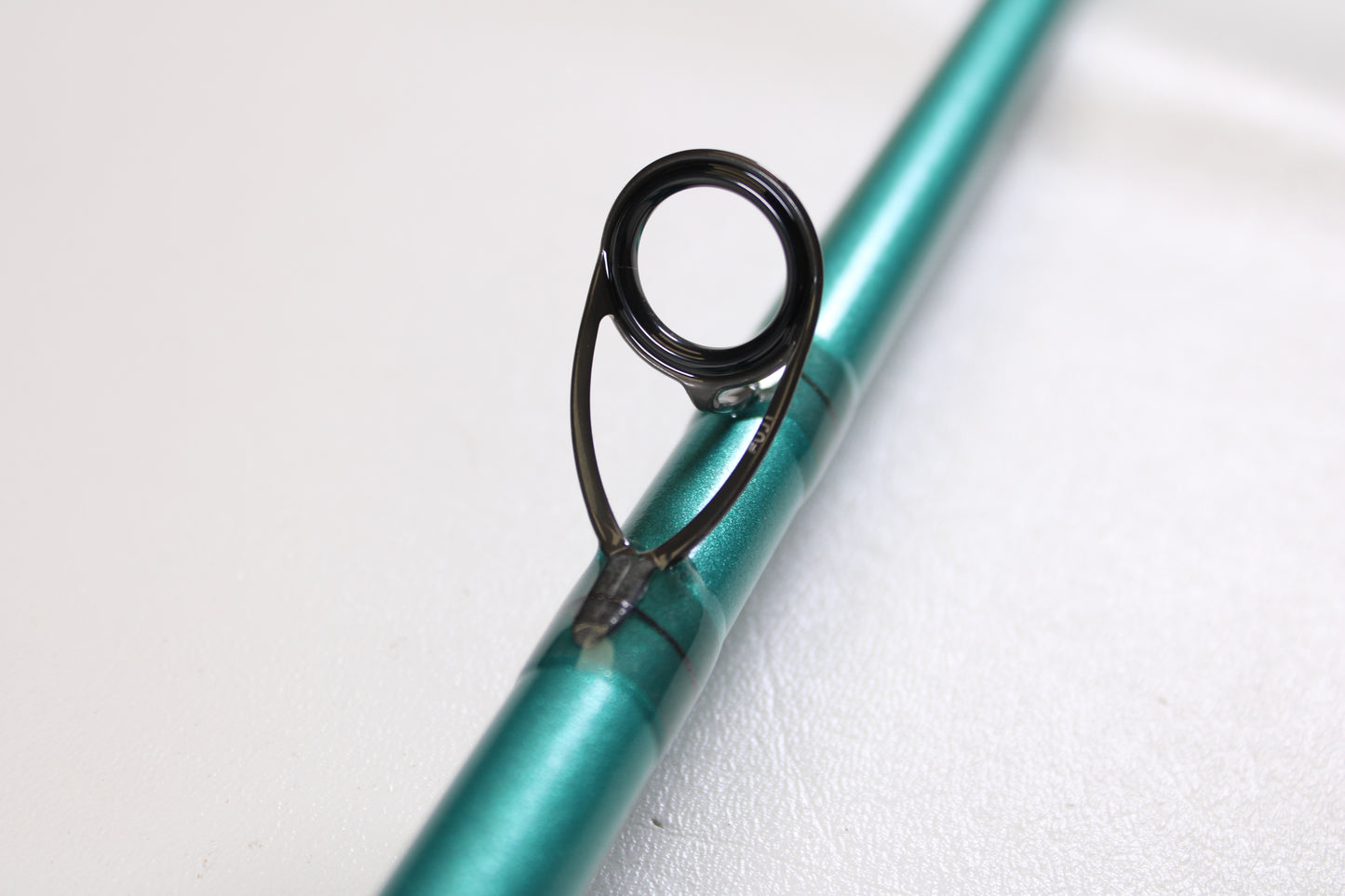 Close-up of a St. Croix Avid Inshore ASIC79XHMF 7'9" Extra Heavy used casting rod in mint condition, highlighting a black line guide—ideal for those considering our rod and reel trade-in program.