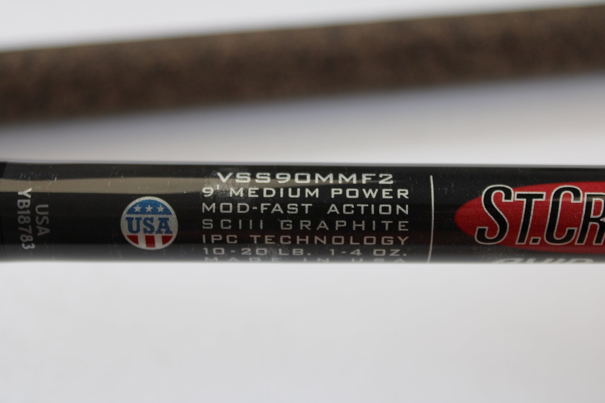 Close-up of the St. Croix Avid Surf VSS90MMF2 9'0" Medium Used Spinning Rod in mint condition, showing specs and a USA flag logo. Eligible for rod and reel trade-in toward store credit on used gear.
