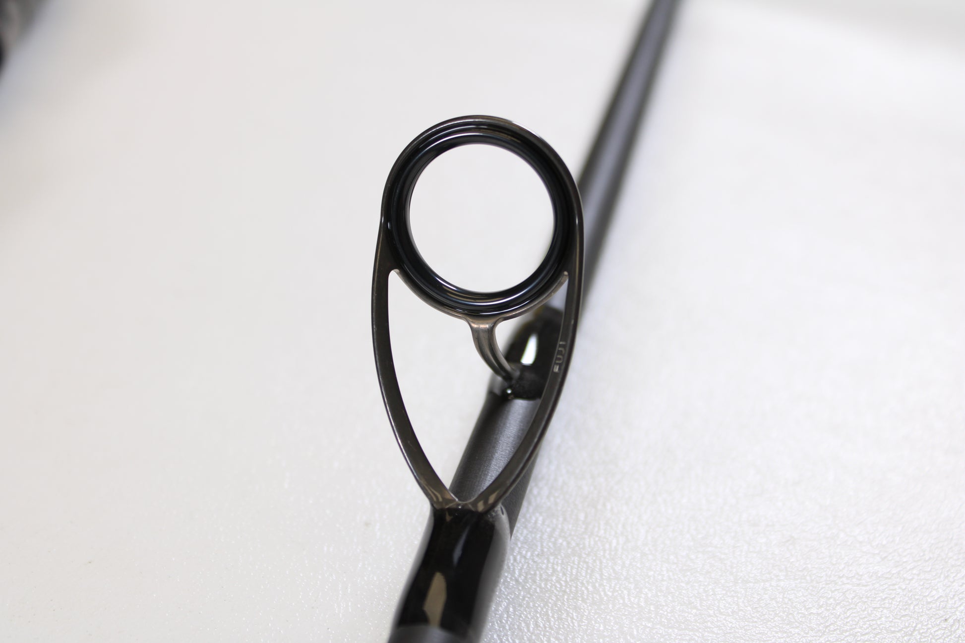 Close-up of the St. Croix Avid Surf VSS90MMF2 9'0" Medium used spinning rod guide, featuring its circular metal ring and support—ideal for enthusiasts interested in high-quality, mint-condition gear or trade-ins.