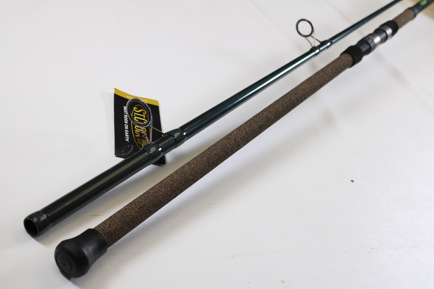 A close-up of the St. Croix Triumph Surf TSF106MH2 10'0" Medium Heavy 2 Piece Used Spinning Rod in mint condition, featuring a cork handle and black rubber end cap—ideal for our Rod and Reel Trade-In Program for store credit.