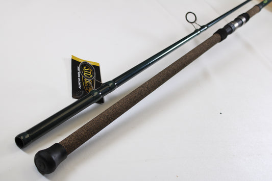 A close-up of the St. Croix Triumph Surf TSF106MH2 10'0" Medium Heavy 2 Piece Used Spinning Rod in mint condition, featuring a cork handle and black rubber end cap—ideal for our Rod and Reel Trade-In Program for store credit.