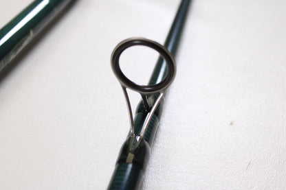 Close-up of the St. Croix Triumph Surf TSF106MH2 10'0" Medium Heavy 2 Piece used spinning rod in mint condition, highlighting its sturdy metal guide—ideal for anglers upgrading gear or using our Rod and Reel Trade-In Program.