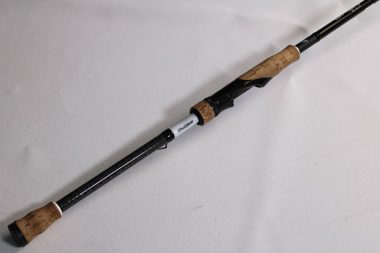 The 13 Fishing Omen Black 3 OB3S75MMAG 7'5" Medium Used Spinning Rod, in very good condition, is shown diagonally on a white surface—ideal for rod and reel trade-in or used gear offers.