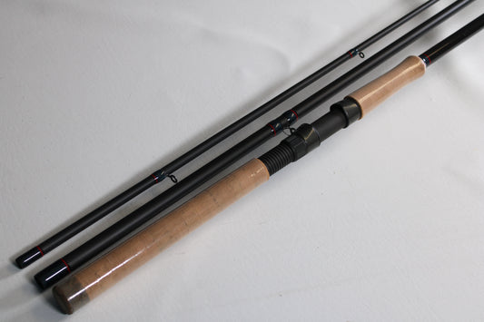 A used Falcon Slab Series SLS13MH 13'0" medium heavy 3-piece spinning rod in excellent condition, perfect for rod and reel trade-in or earning store credit, is displayed on a white surface.