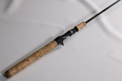 A Falcon Cara T7 CC-4-166M 6'6" Medium Used Casting Rod in very good condition, shown close-up with a cork handle and black reel seat—ideal for those interested in used gear or a rod and reel trade-in.