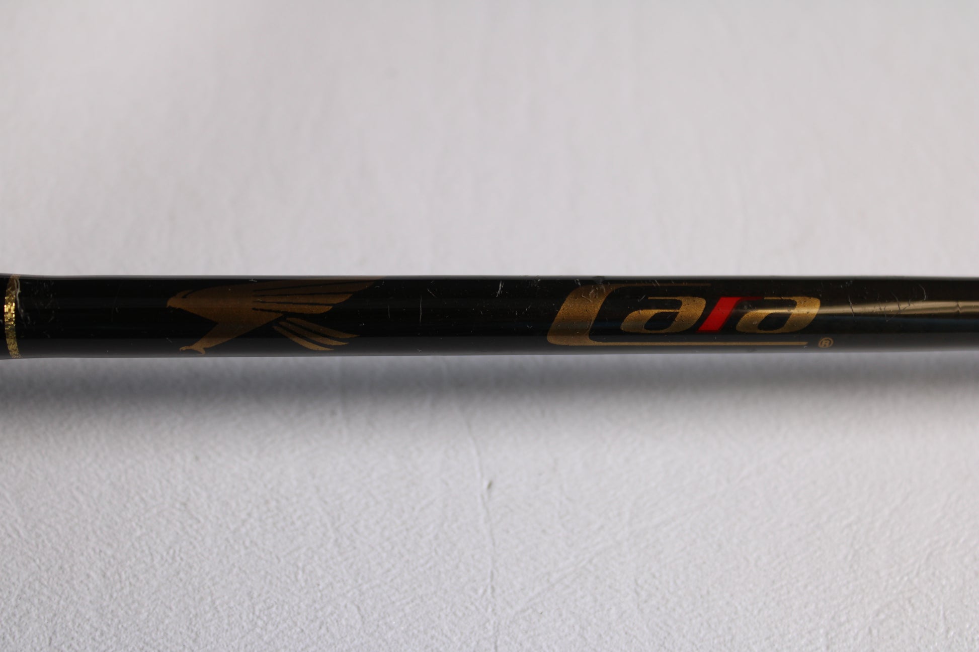 A close-up of a Falcon Cara T7 CC-4-166M 6'6" Medium used casting rod in very good condition, featuring a gold bird logo and "cara" in gold and red—ideal for upgrading via our trade-in program or store credit.