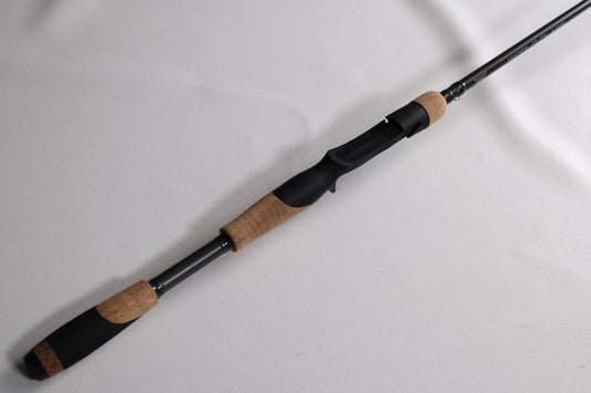 A close-up of the Fenwick World Class Bass WLDCB71M-MFC 7'1" Medium Moderate Used Casting Rod in excellent condition, featuring a black reel seat and cork handle—ideal for trade-in or anyone seeking quality pre-owned Fenwick gear.