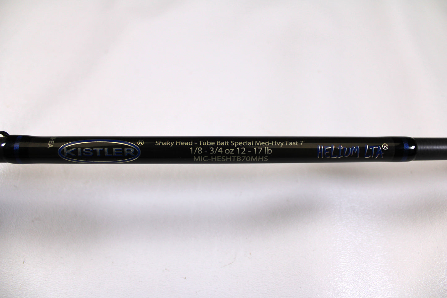 Close-up of a used Kistler Helium MIC-HESHTB70MHS 7'0" Medium Heavy spinning rod in excellent condition on a white background—eligible for our Rod and Reel Trade-In Program for store credit.