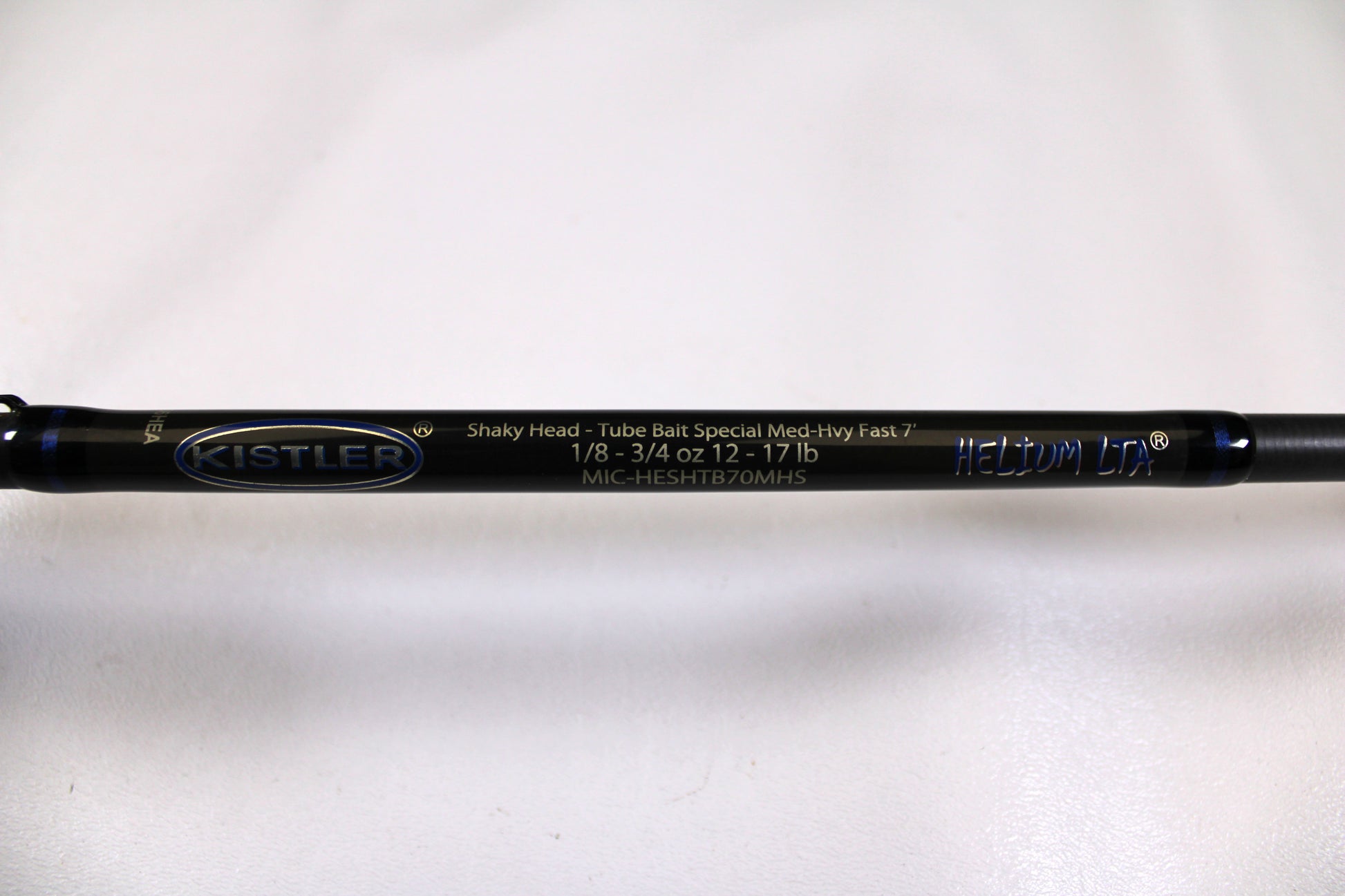 Close-up of a used Kistler Helium MIC-HESHTB70MHS 7'0" Medium Heavy spinning rod in excellent condition on a white background—eligible for our Rod and Reel Trade-In Program for store credit.